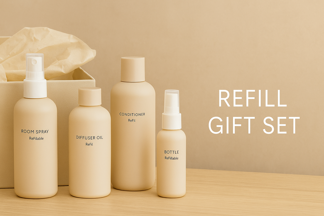 Wide thumbnail showing a minimalist refill gift set with room spray, diffuser oil, conditioner, and a refillable bottle arranged in neutral beige tones on a wooden surface.